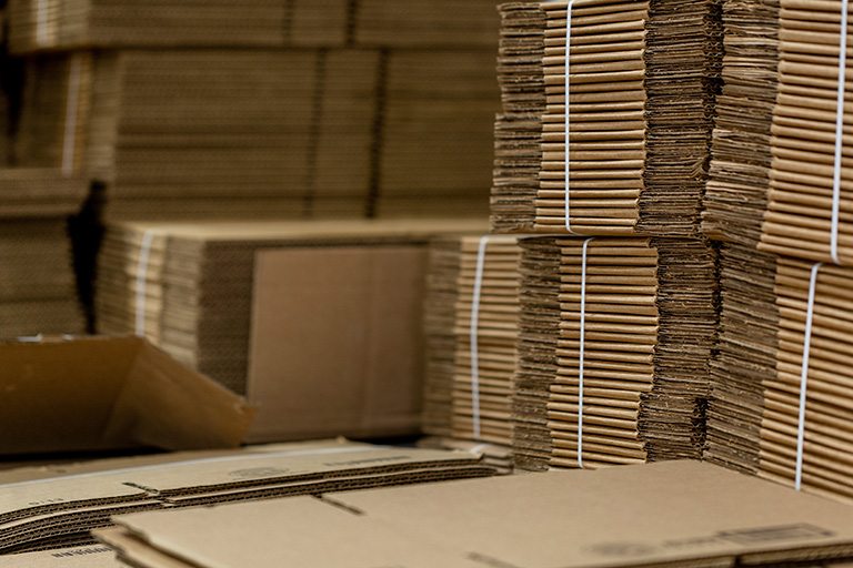Stacks of flattened cardboard boxes.